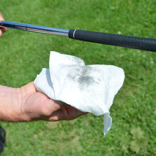Load image into Gallery viewer, person holding a Karma Grip Wipe after cleaning a golf grip