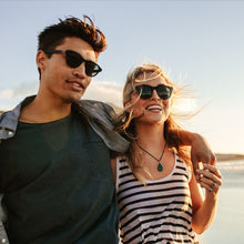 Load image into Gallery viewer, couple on beach wearing Tour Gear Polarized Sunglasses